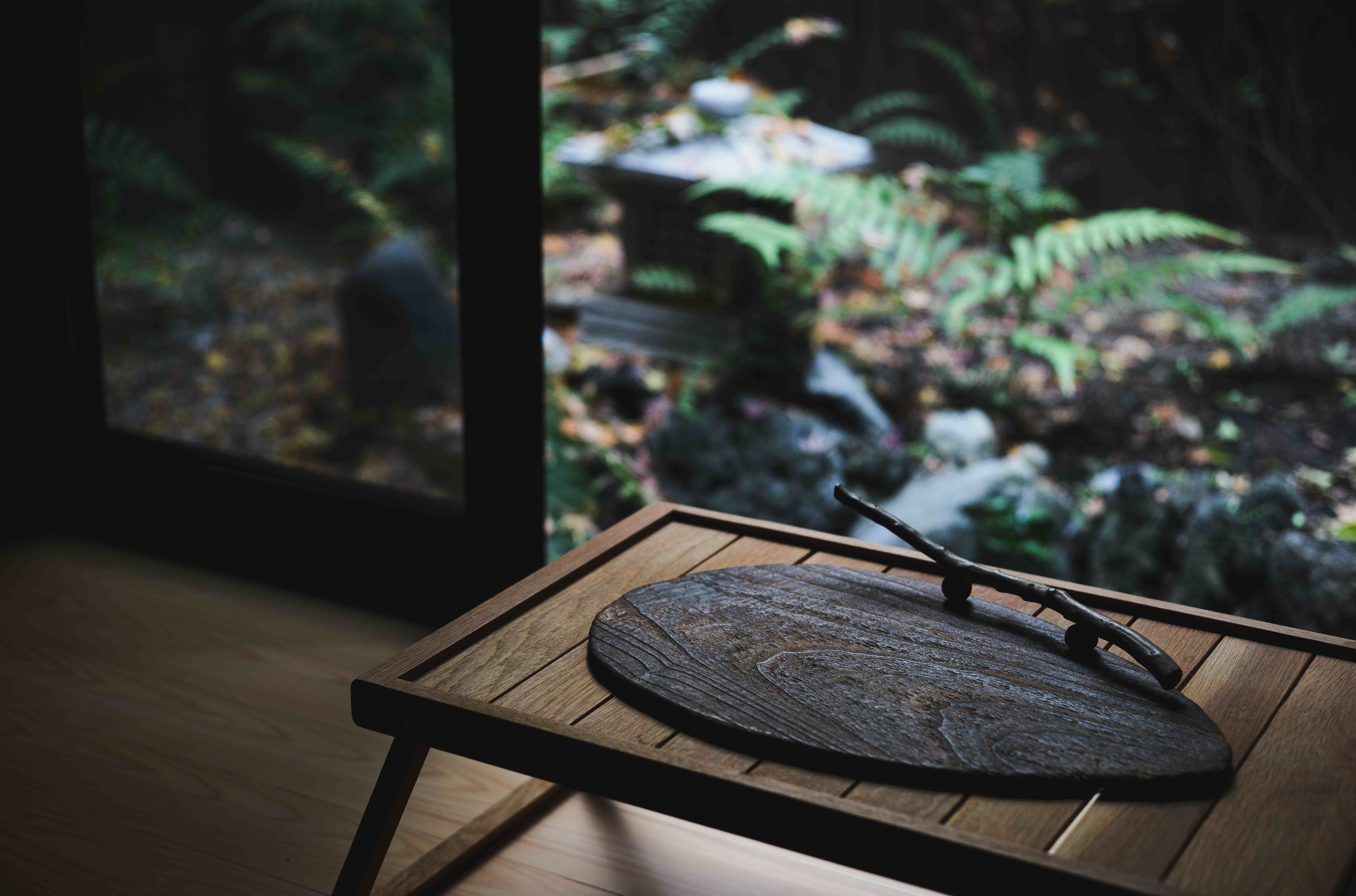 View from Shoshin-An engawa veranda with wooden tray overlooking lush courtyard garden